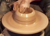 clay being formed on pottery wheel